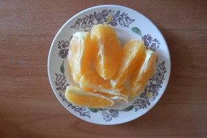Почистите апельсин и разрежьте его на дольки. Удалите косточки.